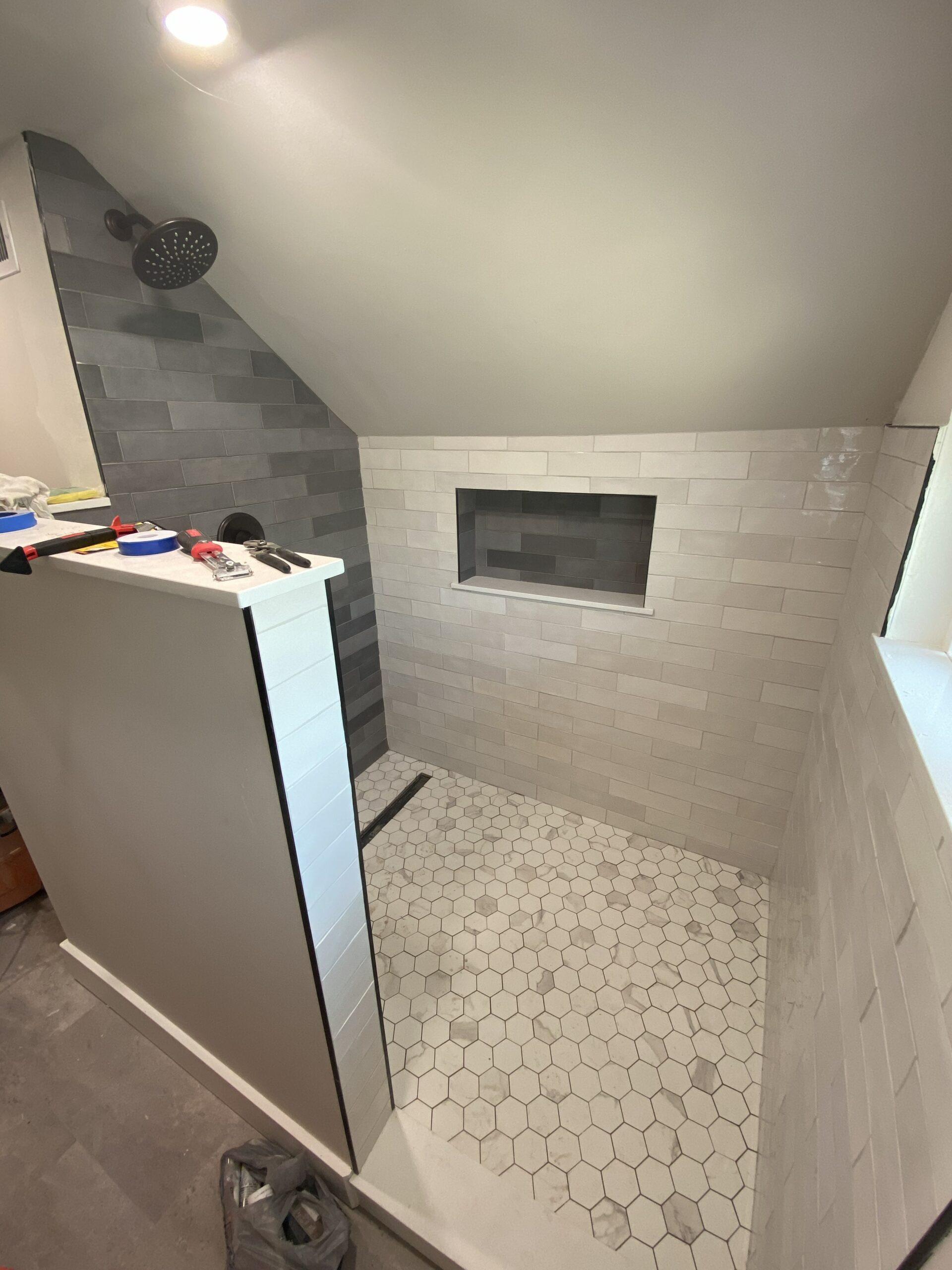 Walk-in shower with bench seat and tile work